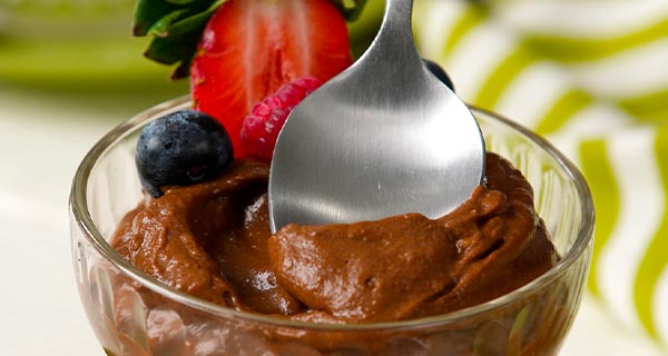 Avocado chocolate pudding in a glass with strawberries