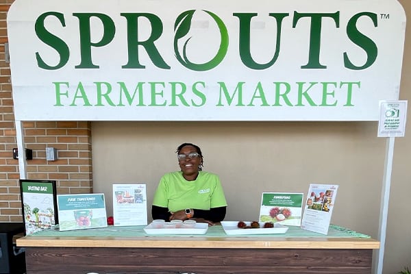 Sprouts associate at welcome booth