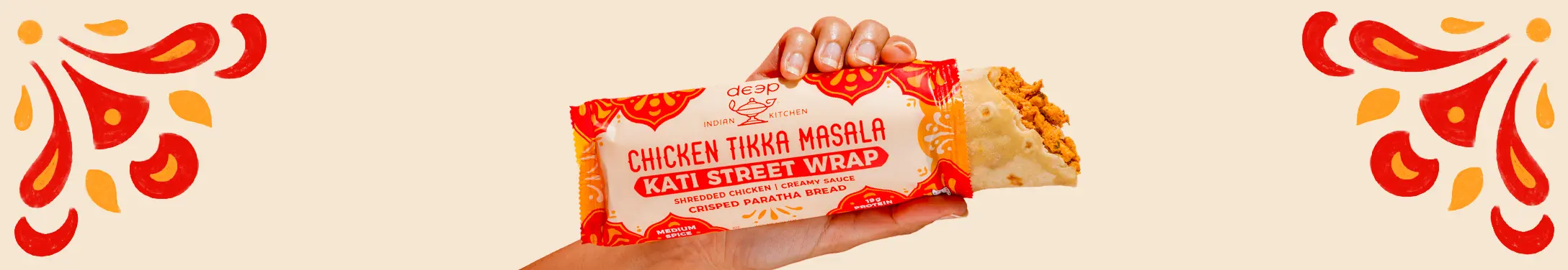 Hand holding chicken tikka masala street wrap.