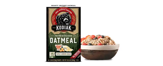 Kodiak Cakes Oatmeal next to a bowl of oatmeal and fruit
